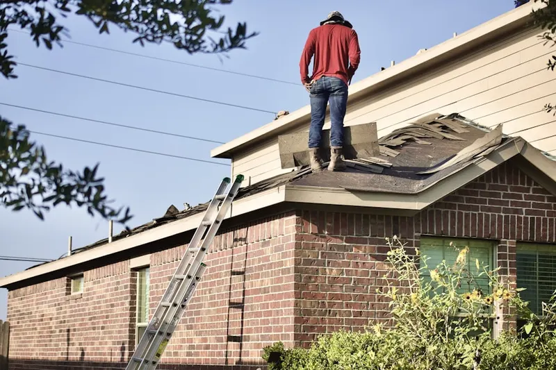 Professional roofer working on a residential roof in Wendel Wood
